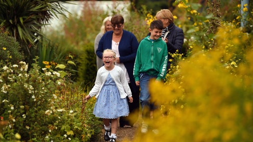Three women and two children walk in the garden at Gunby Hall, Lincolnshire